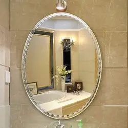 Oval mirror in the bath photo